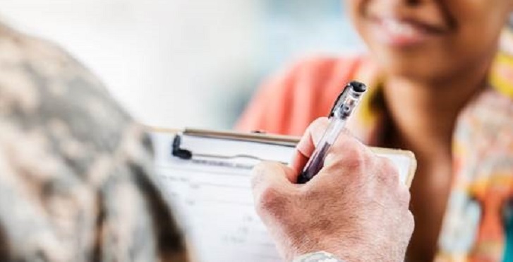 IMAGE: stock image of uniformed arm/hand taking notes