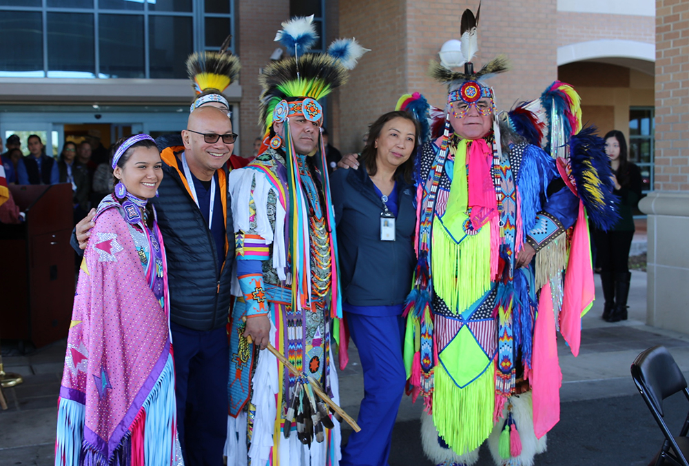 Two VA nurses pose for a group photo with members of the Lipan Apache Tribe of Texas before the start of a special event held in observance of National Native American Heritage Month, which took place at the VA outpatient clinic in Harlingen, Texas, on November 16, 2018. (U.S. Department of Veterans Affairs photo by Luis H. Loza Gutierrez)