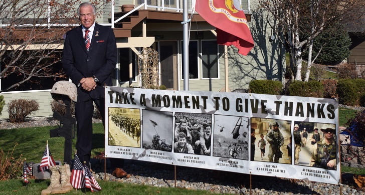 IMAGE: Richard Shutts with a banner outside of his home