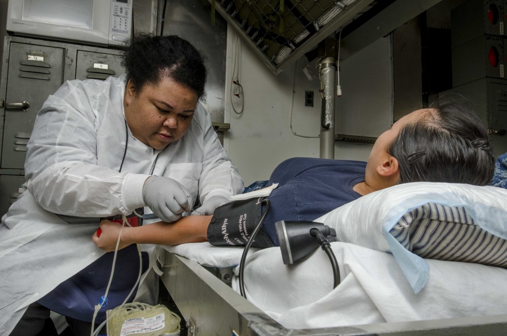 Nurse drawing blood from patient