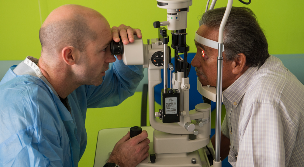 Doctor giving man eye test
