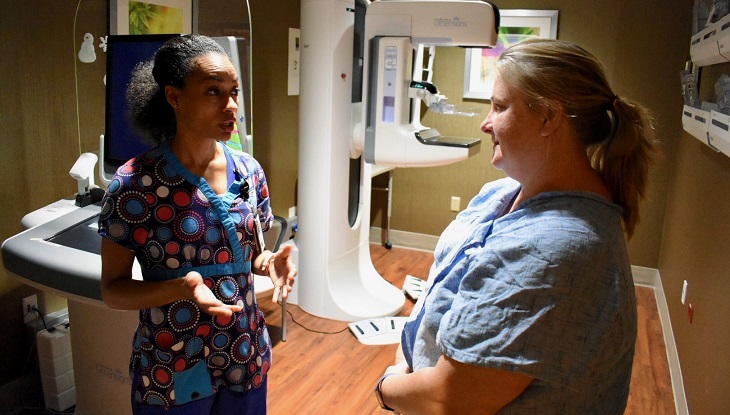 IMAGE: Marlo Trabue, Radiologic Technologist at VA North Texas, answers question from U.S. Navy Veteran Kathy Lowery, during her appointment in the mammography imaging suite.