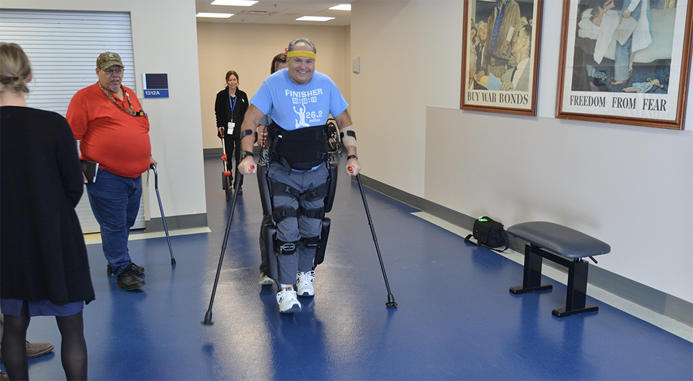 Man walking with robotic exoskeleton