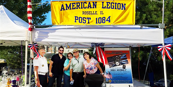 Pictures shows people standing under a canopy, text reads - AMERICAN LEGION - ROSELLE. IL - POST 1084