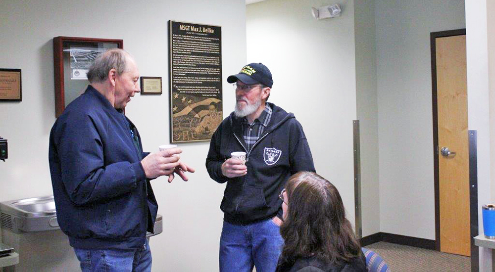 Two Veterans talking while having a cup of coffee
