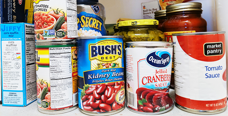 Picture of a pantry with multiple canned foods.