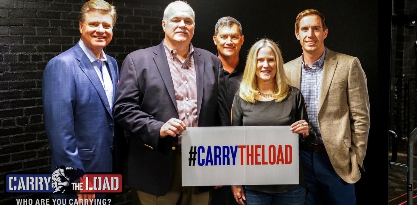Group photo of Pete Delkus, Chief Meteorologist, WFAA; Randy Reeves, Under Secretary for Memorial Affairs; Todd Boeding, Carry The Load Board Member and Marine Veteran; Debbie Wright, Carry The Load Executive Director; Matt Fryman,