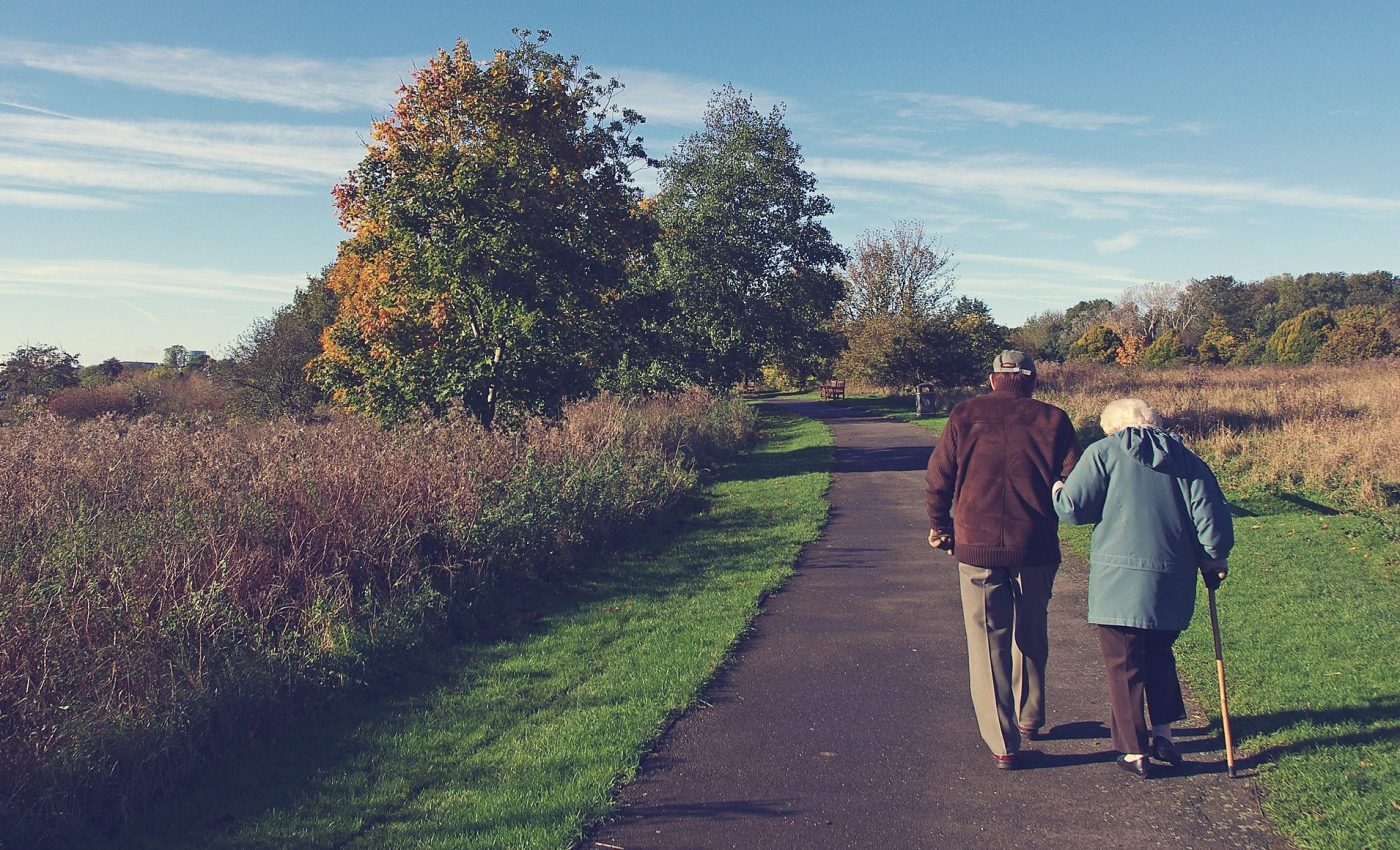 VA life insurance photo of older couple walking in spring