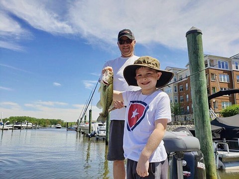 Boy fishing with his father.