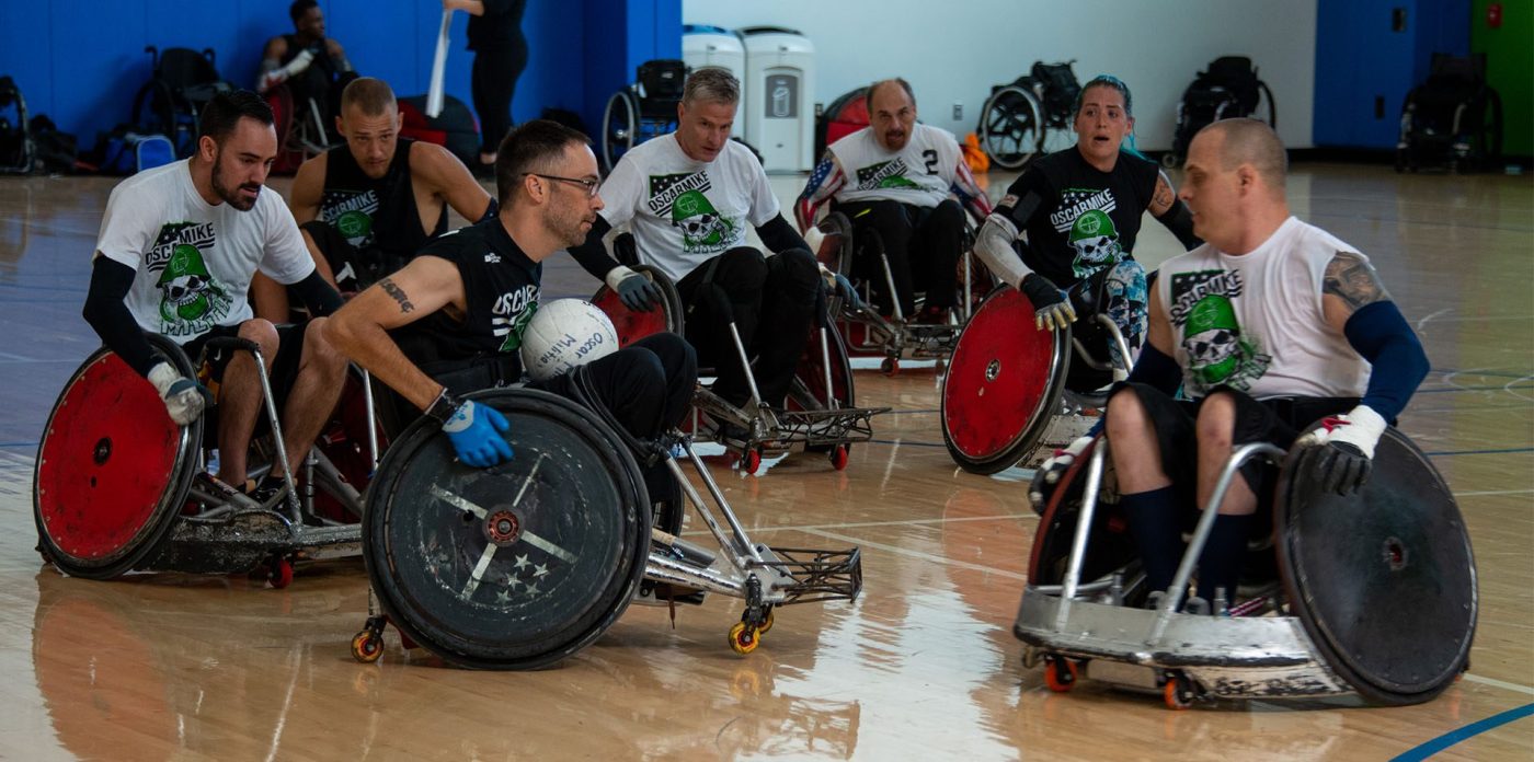 Noah Currier plays wheelchair basketball with fellow Veterans