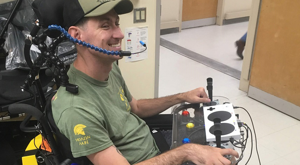 A man in a wheelchair with a custom video game controller