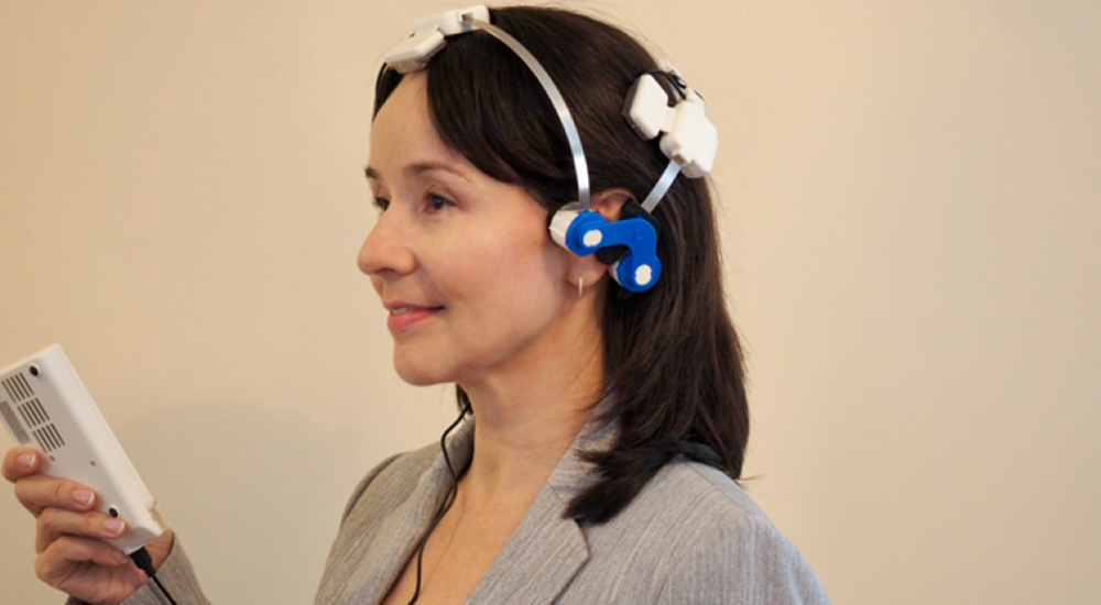 Woman wearing a light-emitting diode therapy headset.