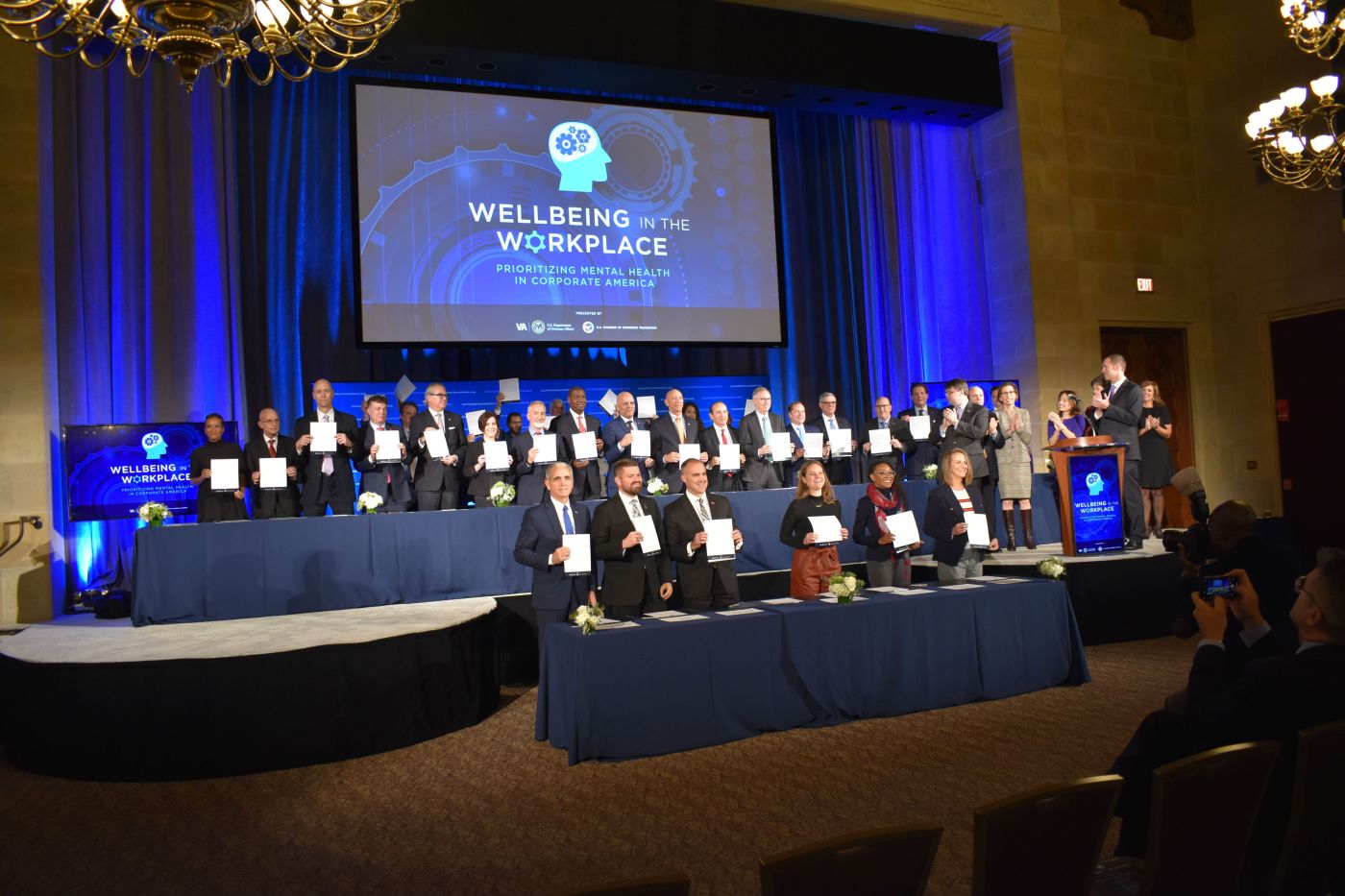Company representatives hold copies of their signed “Pledge to Prioritize Mental Health and Emotional Wellbeing in the Workplace” during a Nov. 13 event at the U.S. Chamber of Commerce in Washington, D.C.