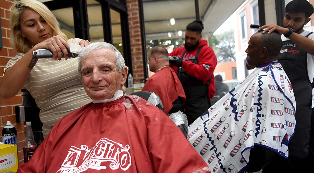 Three men get haircuts at Texas stand down
