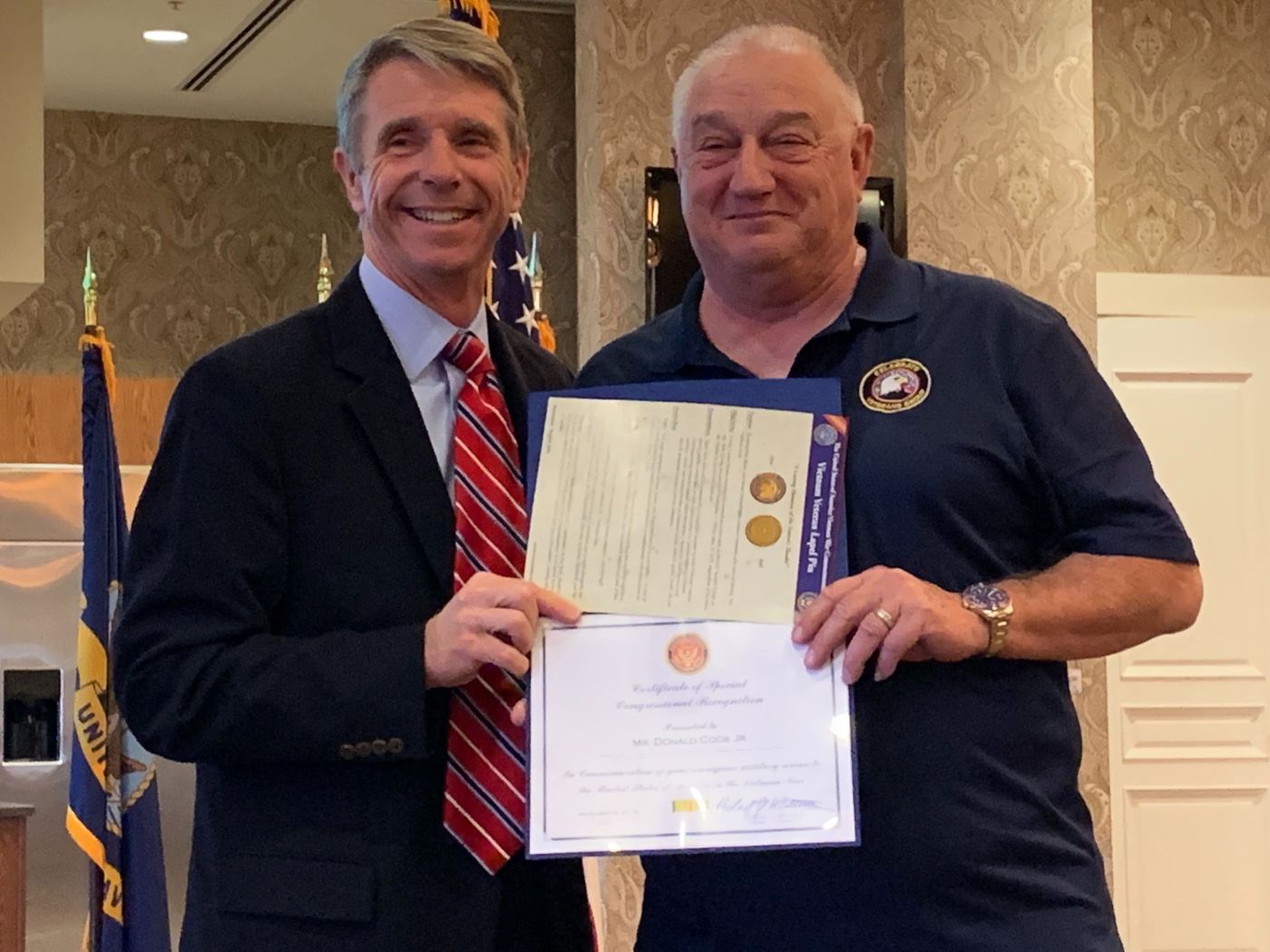 Vietnam Veteran Donald Cook, Jr., receives a certificate and pin from Rep. Rob Wittman during a ceremony Nov. 9, 2019.