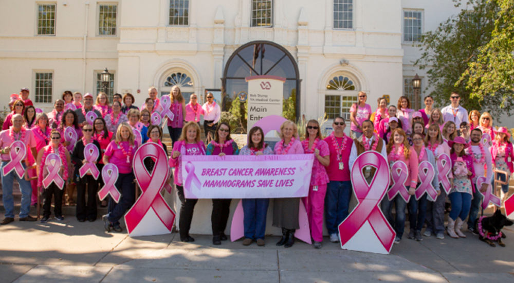 Northern Arizona VA Health Care System staff show their pink in front of the building for breast cancer awareness