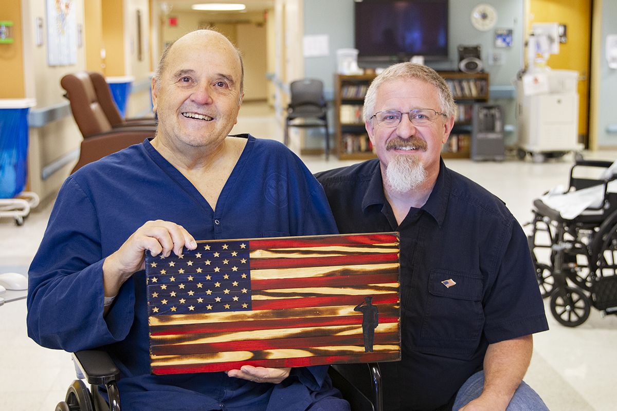 Woodworker gifts handcrafted flags to Veterans