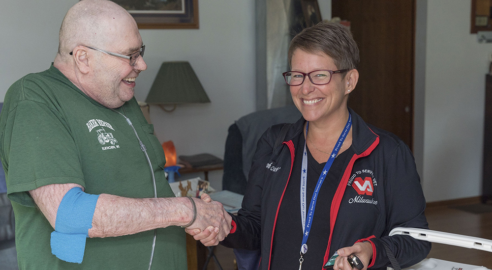 Marine veteran Kenneth Schmitt and RN Farrah Mosely during a home-based primary care visit in Elkhorn, Wisconsin.