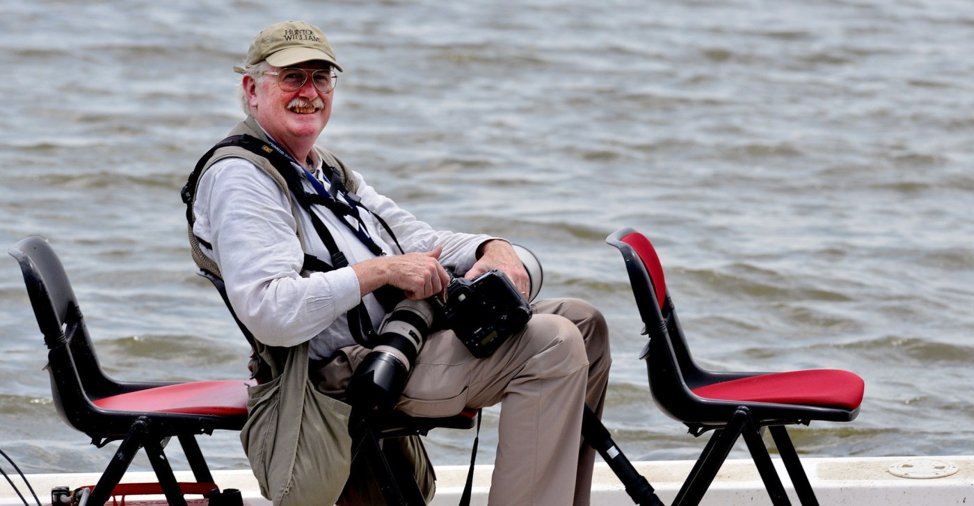 man in boat with cameras