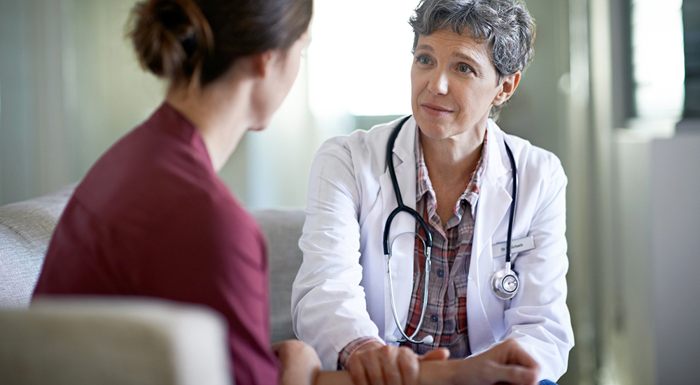 A female doctor talks with a female patient regarding health care for women