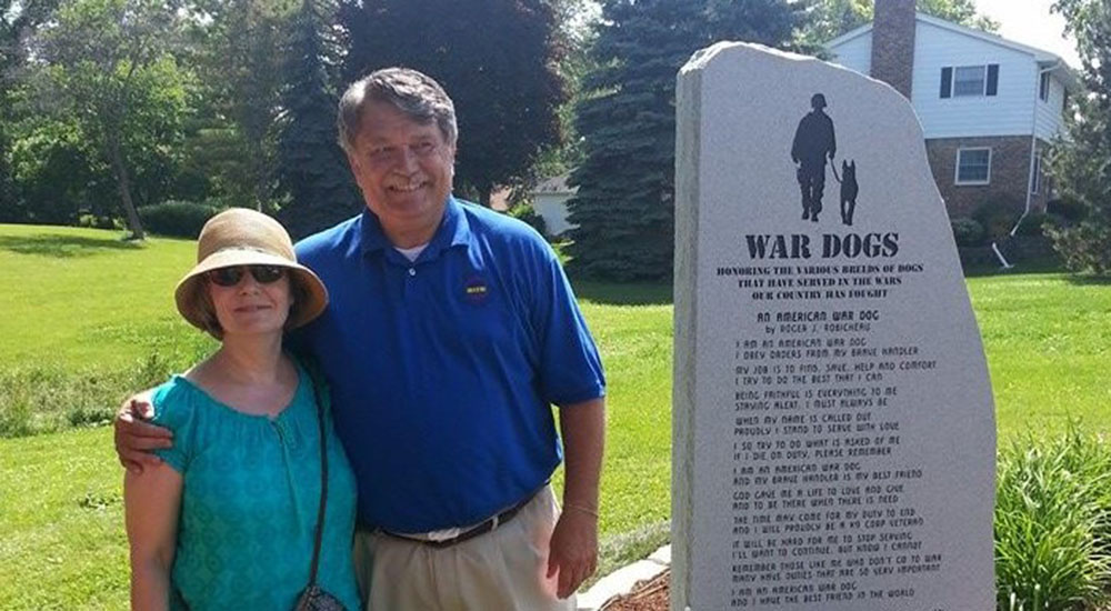 Man and his wife at a monument for dogs