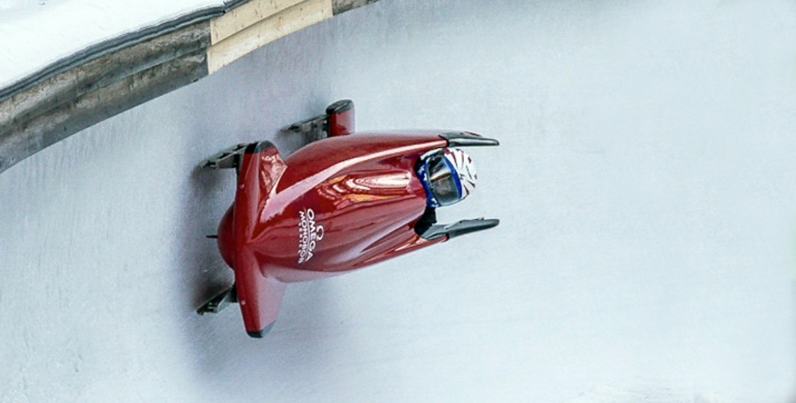 person in bobsled on ice track