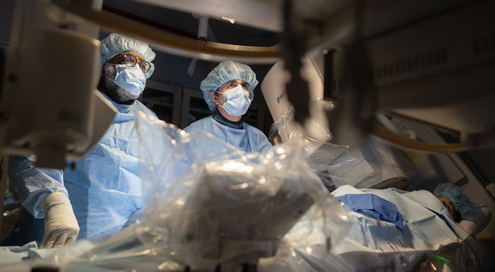 Two doctors watching monitors during surgery