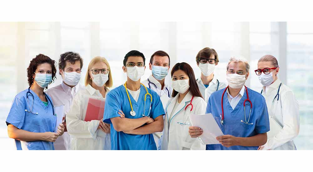 Nine male and female nurses wearing masks