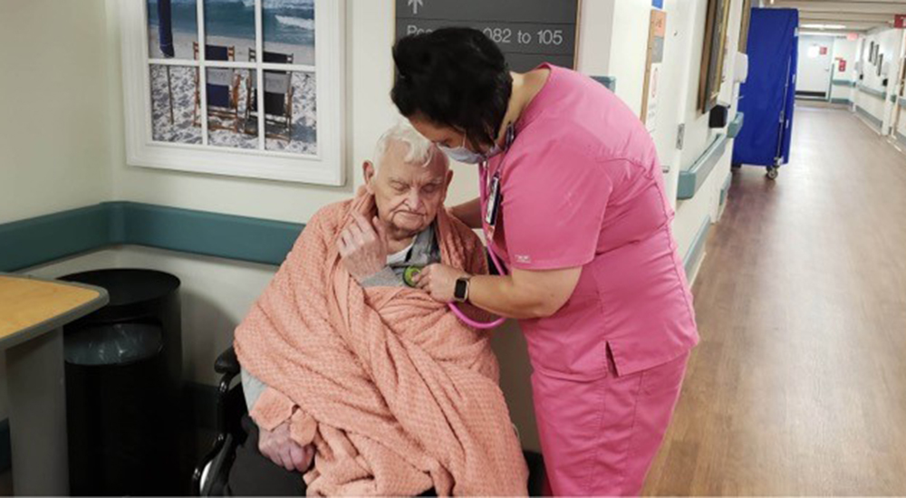 Nurse helping elderly patient in wheelchair