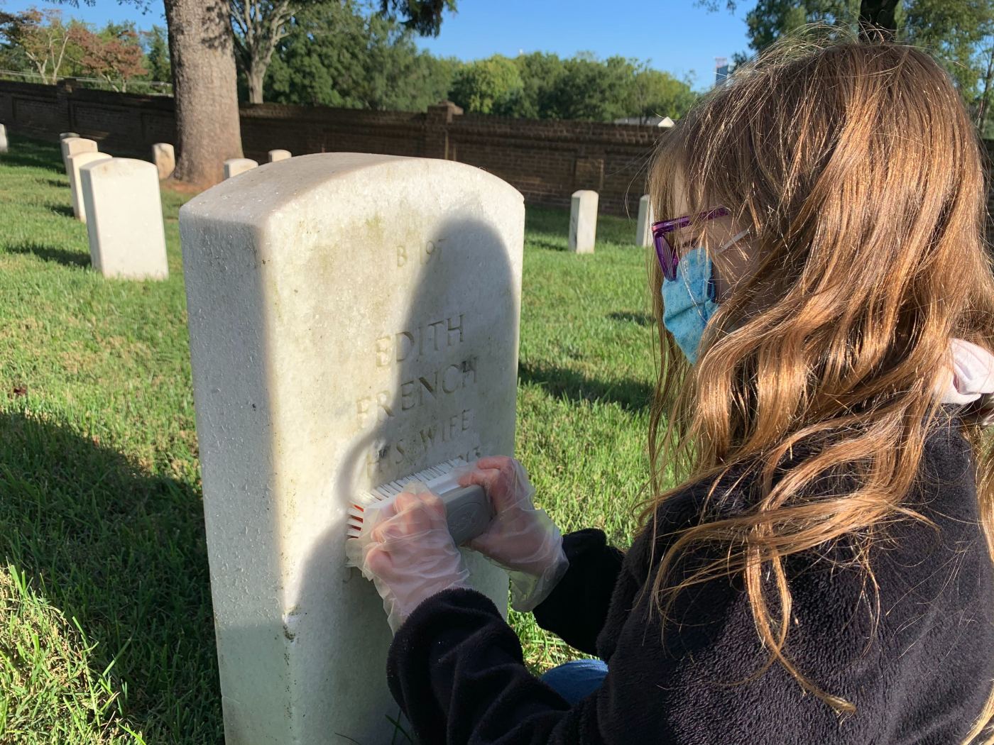 Elleana Bowler cleans a headstone Sept. 19 at Culpeper National Cemetery in Virginia.