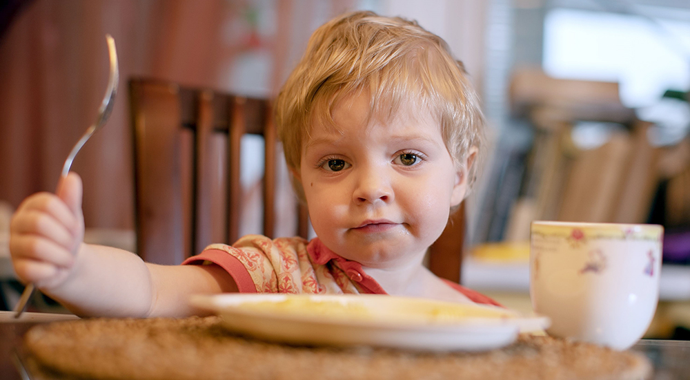 Little boy at a table of food