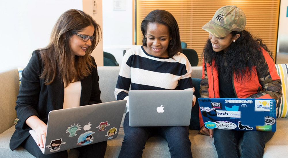 Three women working on laptops
