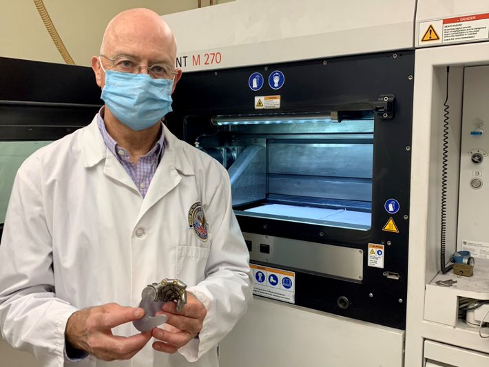 Dr. Richard Weir displays a prototype for one of his ongoing projects. It calls for developing a mechanical finger that can be sized for a female hand using 3D printing technology.