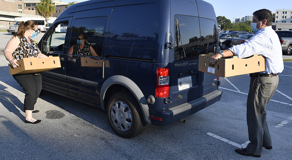 Man and woman loading boxes in a van