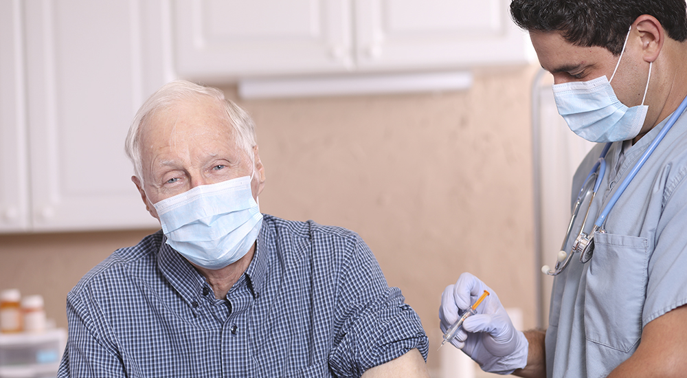Elderly man getting a flu shot