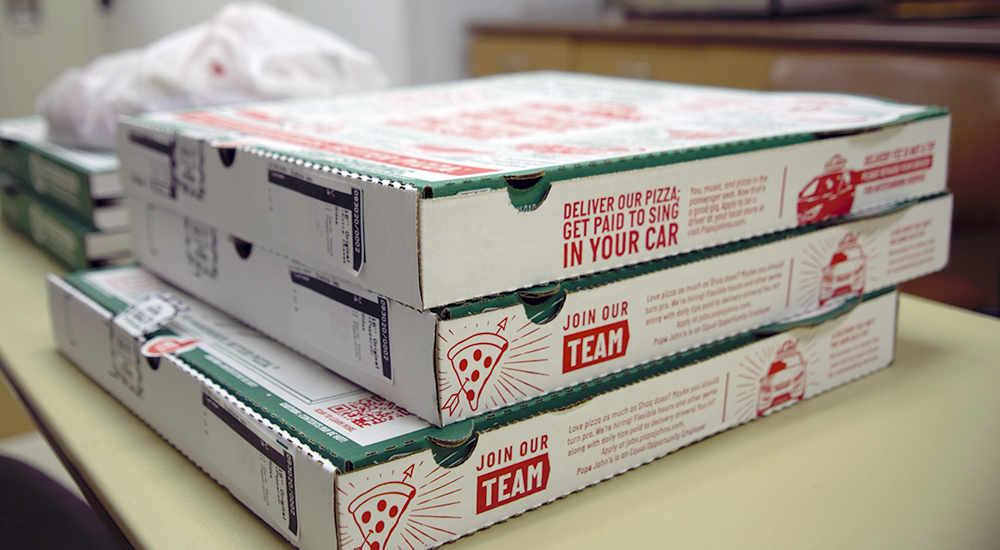 Several large boxes of pizza