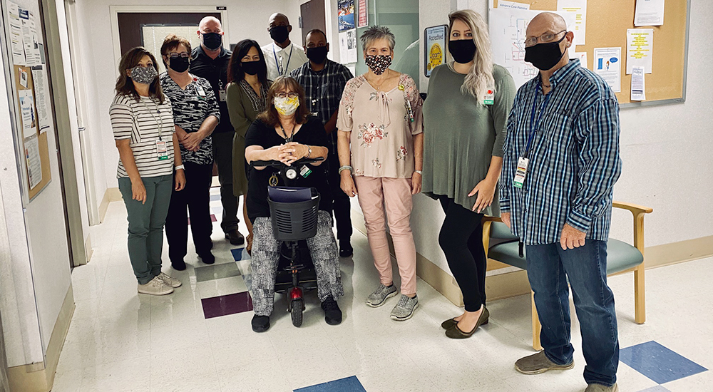 Ten people in hallway wearing masks