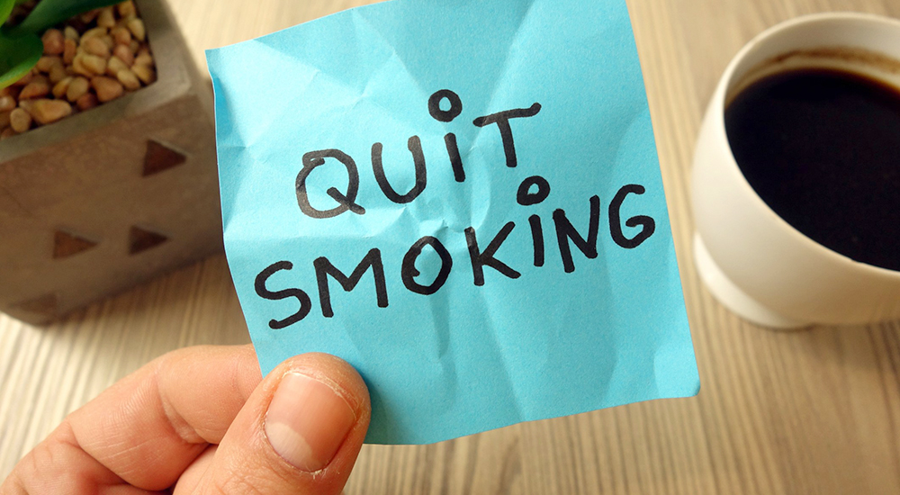 Quit smoking text - motivational reminder handwritten on sticky note