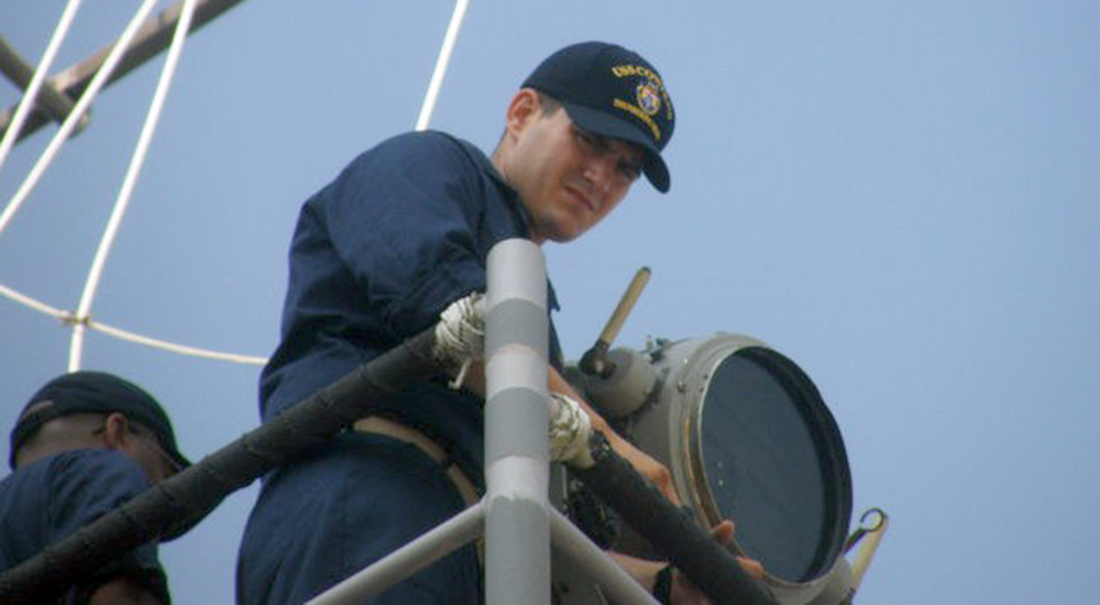 Navy seaman and searchlight on Navy ship