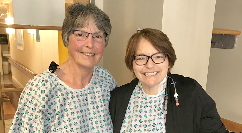 Two women in hospital gowns in hospital