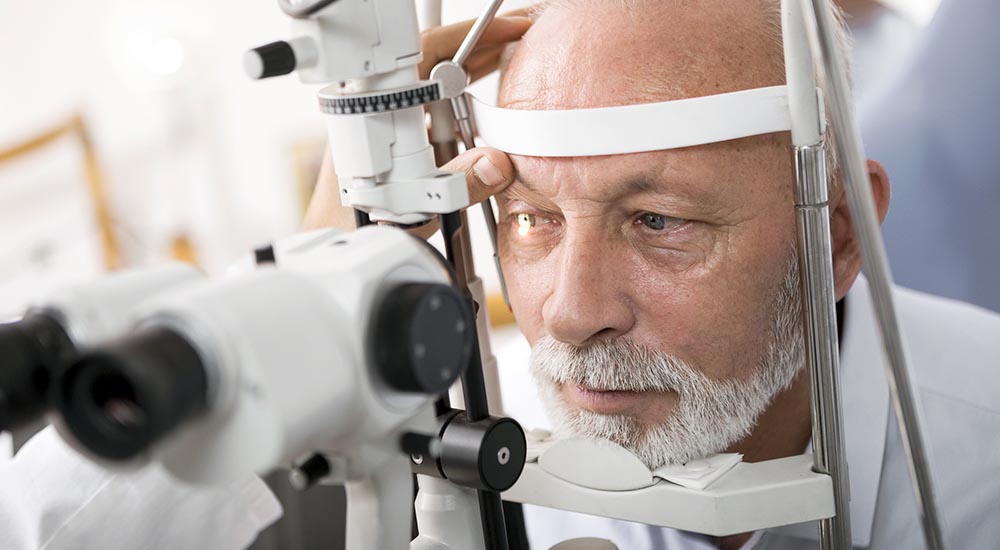 Senior male having eye exam