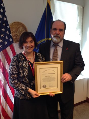 Dr. Robert Jesse, a former VA principal deputy undersecretary for health, presents Rani Elwy with a certificate of appreciation in 2014 for the work she and her team did to improve how VA responds to adverse events.