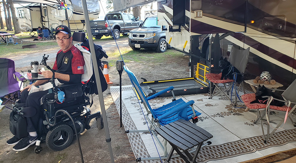 Man in wheelchair in front RV