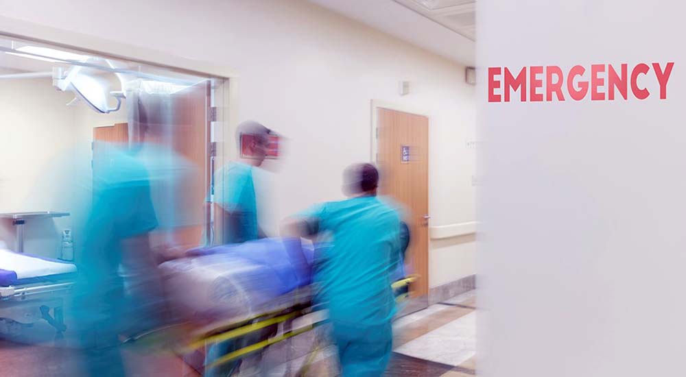 Medical staff rushing with a patient on a cart