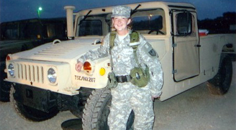 Woman soldier with Army vehicle