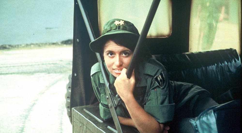 Female nurse in uniform in Army jeep