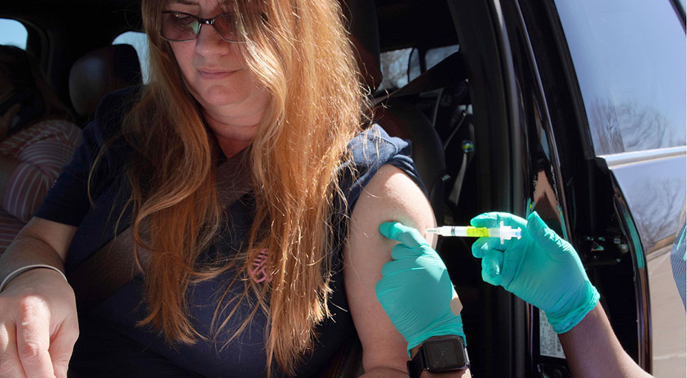 Woman in car receives vaccine