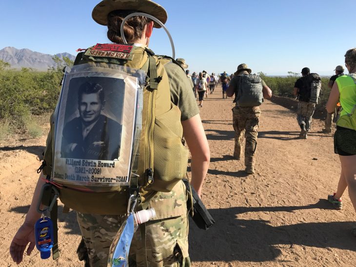 Air Force 2nd Lt. Amber Schoenberger marches in the Bataan Memorial Death March Marathon March 19, 2017, at White Sands Missile Range, New Mexico, in honor of her grandfather (pictured on her backpack), U.S. Army Air Forces Cpl. Willard Edwin Howard (1921-2009), who survived the grueling march in 1942. (Courtesy photo)