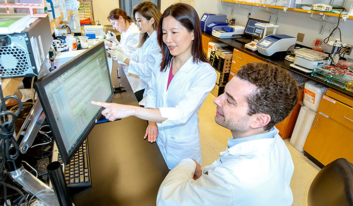 In their lab at the Atlanta VA and Emory University, Dr. Thomas Wingo and Dr. Aliza Wingo (foreground) have found genes and corresponding proteins that could open doors for new depression treatments.