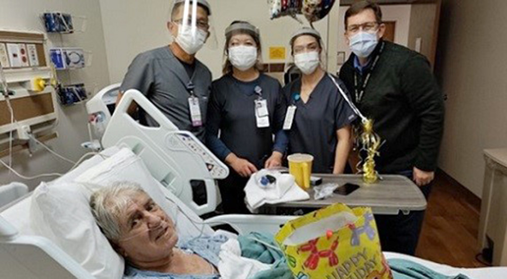 Four people at a Veterans’ hospital bedside